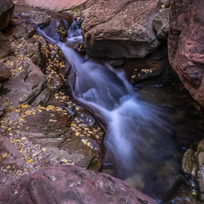 a large waterfall over a rocky cliff