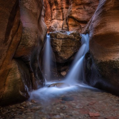 a large waterfall over some water