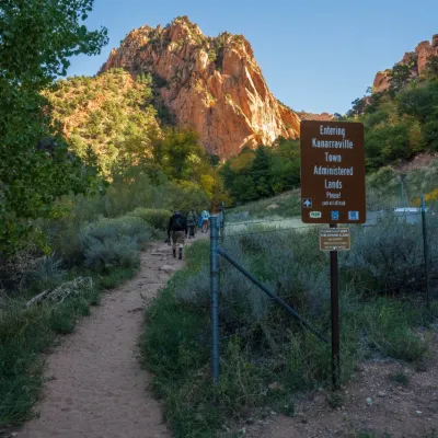a sign on the side of a dirt road