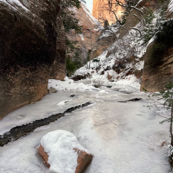 a pile of snow next to a rock
