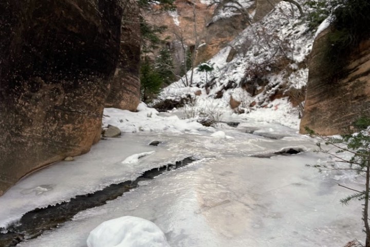 a pile of snow next to a rock